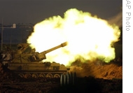 A mobile artillery piece fires towards targets in the southern Gaza Strip, on the Israel side of the border with Gaza, 10 Jan 2009