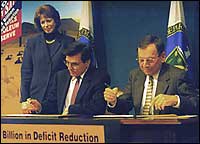 Energy Secretary Federico Pe?a (left) and Occidental Petroleum's David Hentschel sign the historic transfer agreement with Patricia Godley, DOE's Assistant Secretary for Fossil Energy, who orchestrated the sale, looking on.