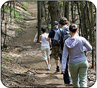 Image of teens hiking through the woods