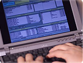 Photo of a person entering data on a computer.
