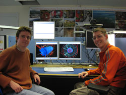 Physics doctoral students Greyson Williams (left) and Phillip Killewald in the Compact Muon Solenoid (CMS) experiment control center.