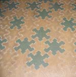 Original yellow (darkened over the years) and green interlocking tile linoleum from the servants dinning room at the home of Thomas and Mina Edison.
