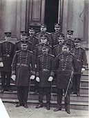 Public Health Service officers in uniform stand on the steps of a PHS hospital. 