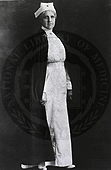 A black and white photograph of a nurse in an early twentieth century uniform.