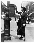 Black and white photo of a woman mailing a letter.