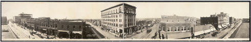 Panoramic view of  Tulsa, Oklahoma.  Shows several buildings, pedestrians, horse drawn carriages and trolley car.