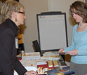 Photo of Jan Kettlewell discussing PRISM with Holly Smith