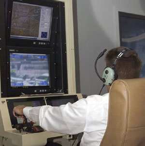 NOAA image showing pilot sitting at a console flying the Altair unmanned aircraft system, or UAS.