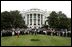 President George W. Bush, Mrs. Bush, Vice President Dick Cheney and Mrs. Cheney, center, are joined by White House staff and families of victims of 911 for a Moment of Silence on the South Lawn at 8:46am, Saturday, Sept. 11, 2004.