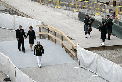 After laying a wreath in the north tower reflecting pool, President George W. Bush and Laura Bush walk through the World Trade Center site to lay a second wreath in the south tower reflecting pool to commemorate the fifth anniversary of the September 11th terrorist attacks in New York City Sunday, September 10, 2006.