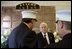 Commemorating the two-year anniversary of the terrorist attacks, Vice President Dick Cheney visits the firehouse of FDNY Rescue Company 1 in New York, N.Y., Sept. 11, 2003. Pictured in the background is a memorial to the station's firefighters who have died in the line of duty, including the company's eleven firefighters who lost their lives Sept. 11, 2001. 