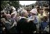 President George W. Bush holds Keira Corrigan of Mineola, N.Y., as he meets some of the hundreds of family and friends who gathered on the South Lawn of the White House, Friday, Sept. 9, 2005, during the 9/11 Heroes Medal of Valor Award Ceremony, in honor of the courage and commitment of emergency services personnel who died on Sept. 11, 2001.