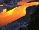 Rivers of molten rock leave a lava tube and flow seaward across a young outcropping of land at the Ka`ili`ili entry on Kilauea volcano in Hawaii on Feb. 20, 2005.