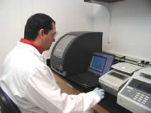 Photo of a CDC laboratorian with real-time PCR equipment.