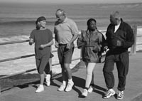 Photo of two couples jogging by the beach.