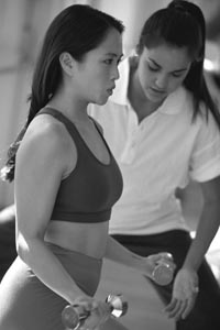 Photo of woman working out with female trainer.