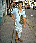 Man on street with polio.