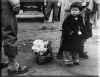 child waiting to be sent to internment camp