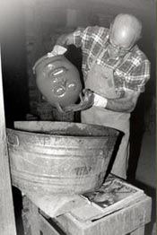 C. J. Meaders glazing a face jug