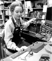 Erika Brady duplicates a wax cylinder recording from the machine to her left using the tape recording machine to her right, 1979
