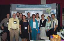 Photo of scientists in front of their booth