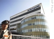 A security personnel stands guard in front of the office of Satyam Computer Services Ltd., in Hyderabad, India, 07 Jan 2009