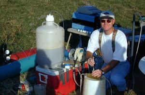 USGS scientist collecting water-quality samples during a hydrogen-consuming, push-pull injection test at the Norman Municipal Landfill Research Site, Okla. The test is used to determine what microbiological processes are active in the subsurface at ground-water contamination sites. 