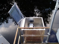 An autosampler set up to collect water samples for analysis of pesticides during storm events as part of a reconnaissance of stream waters in peanut production areas in the southeastern United States. The autosampler was located on Black Creek near Blitchton, GA (circa 2003)