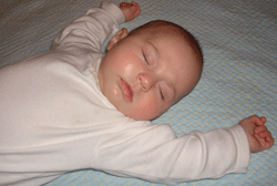 Photo of sleeping baby on her back.