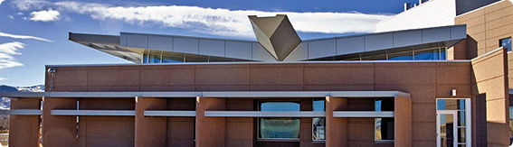 Photo of NREL's Science and Technology Facility with a butterfly roof that collects storm water and directs it to a xeriscaped landscaping irrigation system.