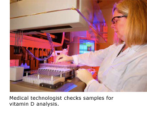 Medical technologist checks samples for vitamin D analysis.