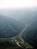 Aerial view showing hills and a creek.