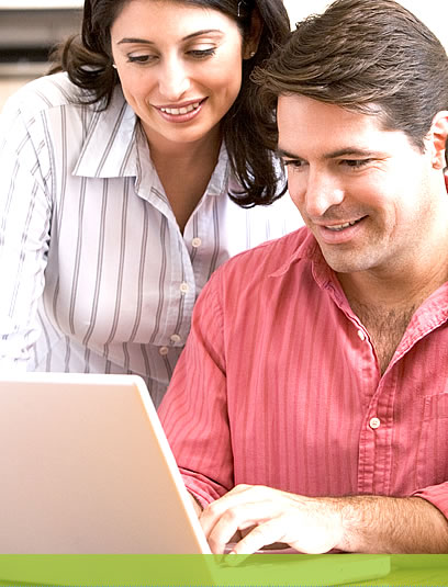 Photo of a couple looking at a laptop screen