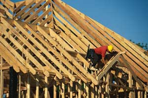 Construction worker on rood trusses