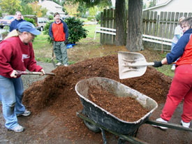 GreenCare volunteers help out with a mulching project. (Photo courtesy of GreenCare.)