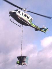 Helicopter spreading dry material