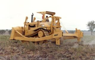 Rootplow on large crawler tractor