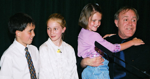 Robert Hass with three young 2001 River of Words winners: Travis Baker, age 7; Elsinore Smidth, age 11; and Shannon O'Keefe, age 7