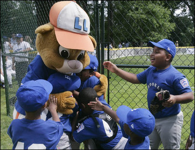 Players from the Inner City Little League of Brooklyn, N.Y. give a group hug to Dugout, the Little League mascot Sunday, July 15, 2007 at the White House Tee Ball Game, played in honor of baseball legend Jackie Robinson between Inner City and the Wrigley Little League Dodgers of Los Angeles.