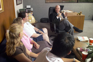 students with dean in his office