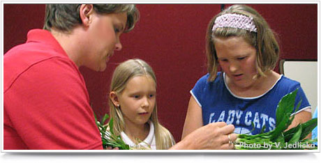 Deanna Karmazin (left) working with participants at 4-H Clover College