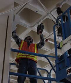 Figure 1.Photo 1 showing typical method for overhead drilling while in a scissor lift or on a ladder.