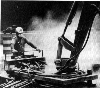 Figure 4. Drilling of concrete pavement containing crystalline silica during interstate highway repair