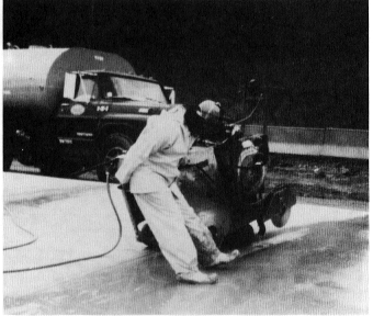 Figure 6. Sawing of concrete pavement containing crystalline silica during highway construction