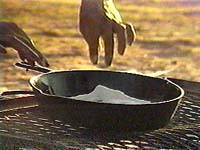 Navajo woman cooking (frying pan)