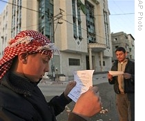 Palestinians read leaflets dropped by Israeli aircraft over their houses in Rafah refugee camp, southern Gaza Strip, 7 Jan. 2009