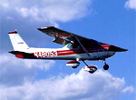 Small red and white airplane in flight