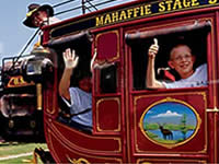 People waving from a stagecoach