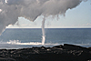 Waterspout spins between steaming water and large plume