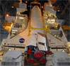 Discovery is lowered alongside the external fuel tank and rocket boosters